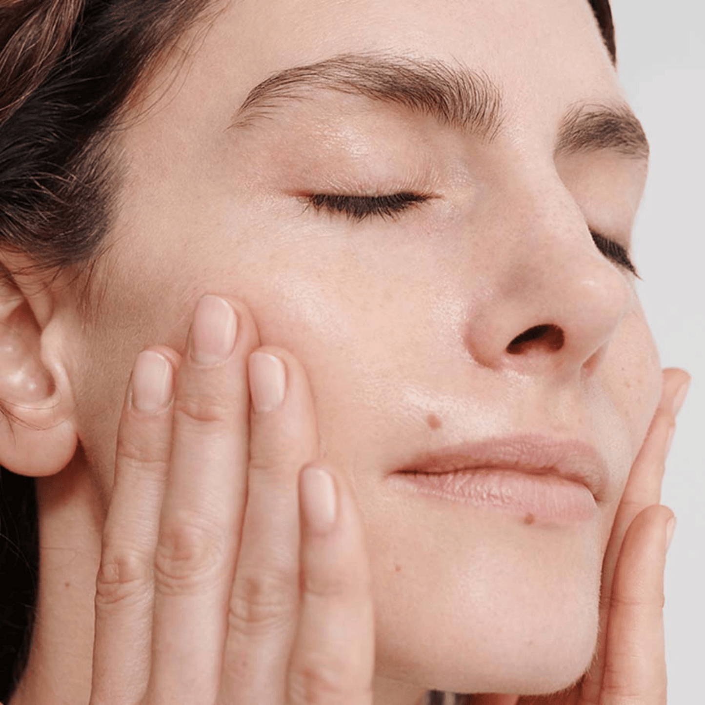 Alternate image of model applying treatment to face