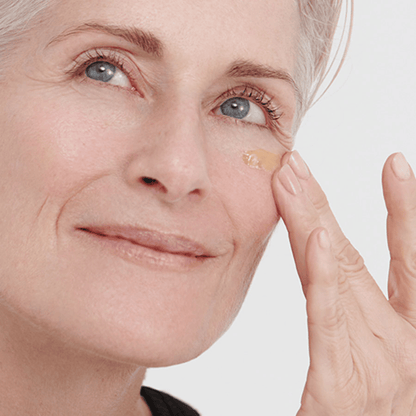 Alternate image of model applying serum to face