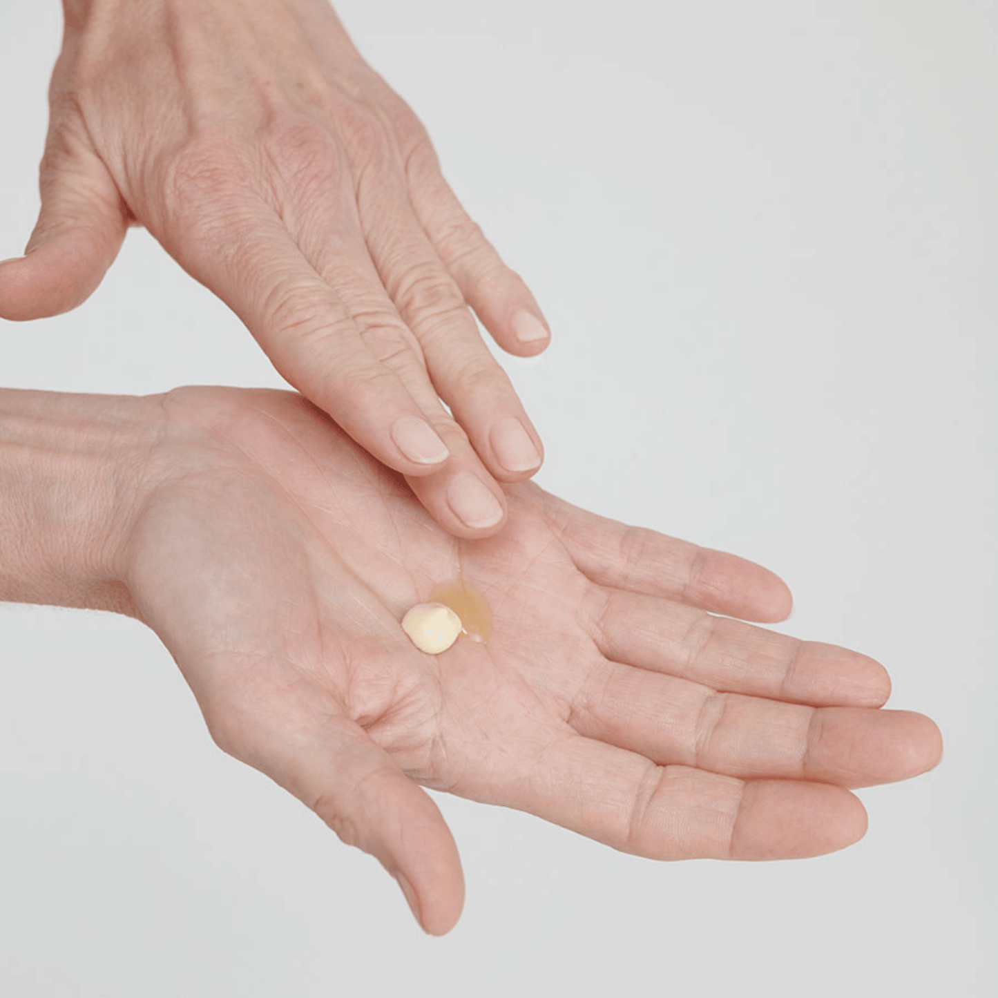 Alternate image of model applying oil serum mixed with cream
