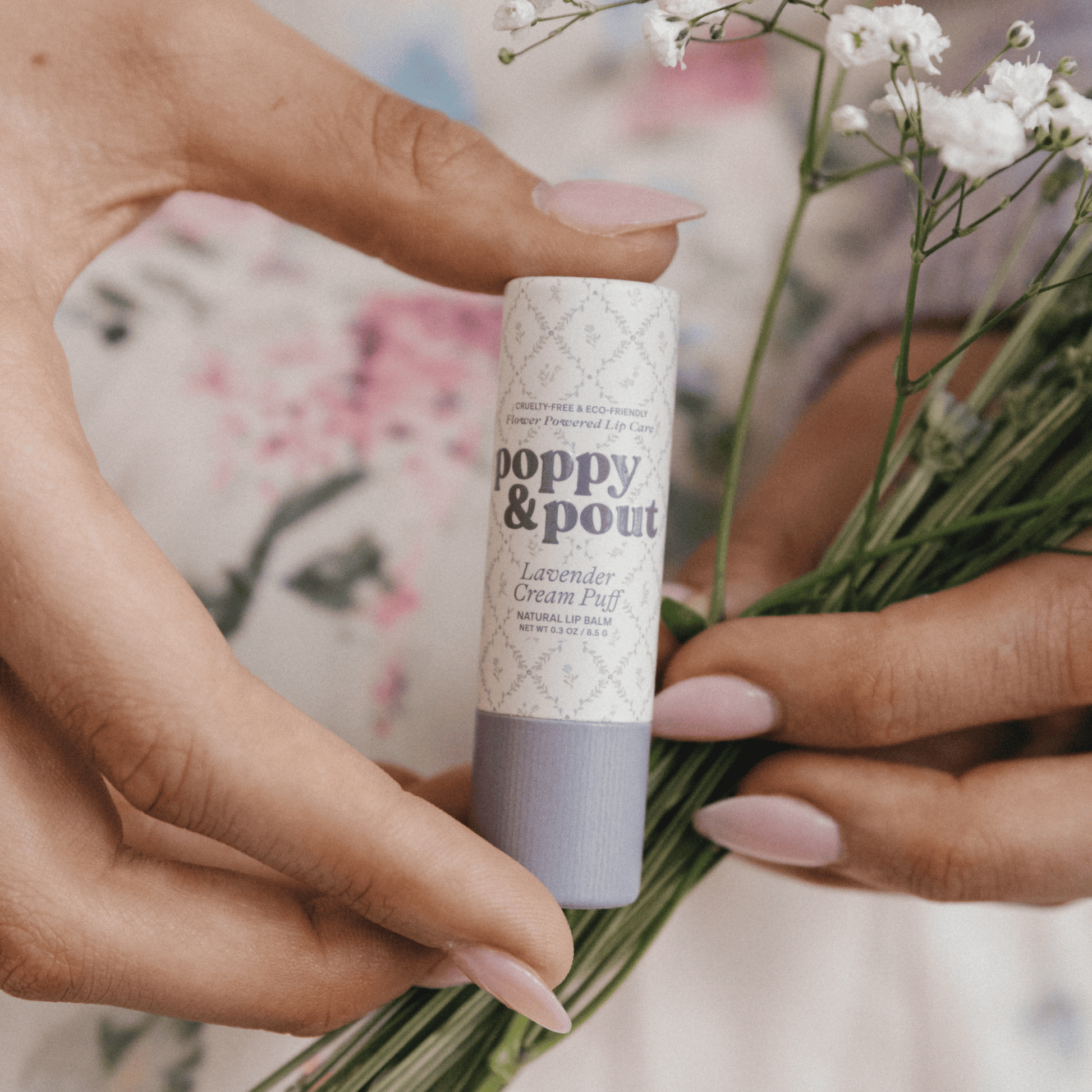 Hand image of Poppy & Pout Lavender Cream Puff Cottage Collection Lip Balm 