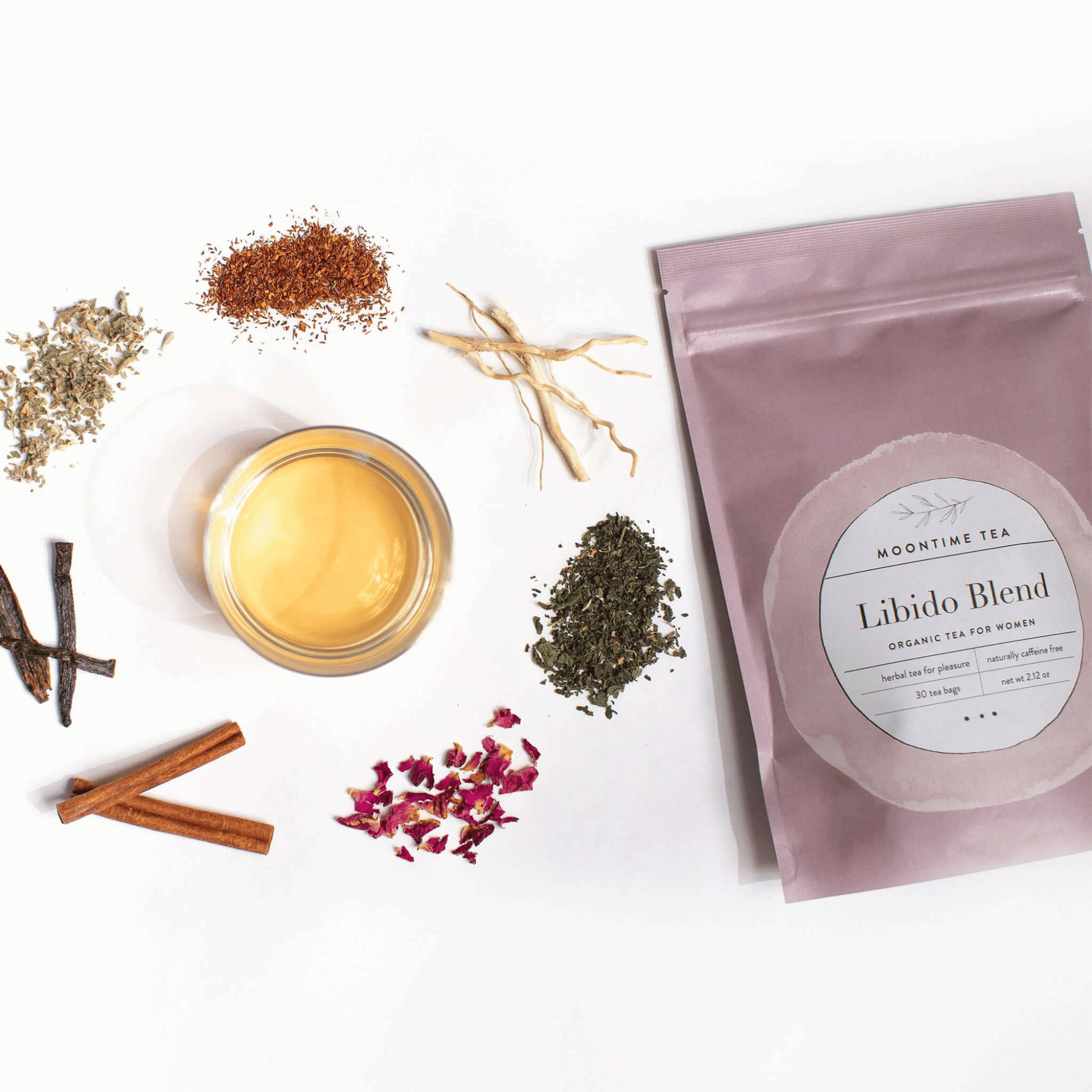 Alternate image of cup of tea surrounded by leaves and flowers from the tea and bag of tea