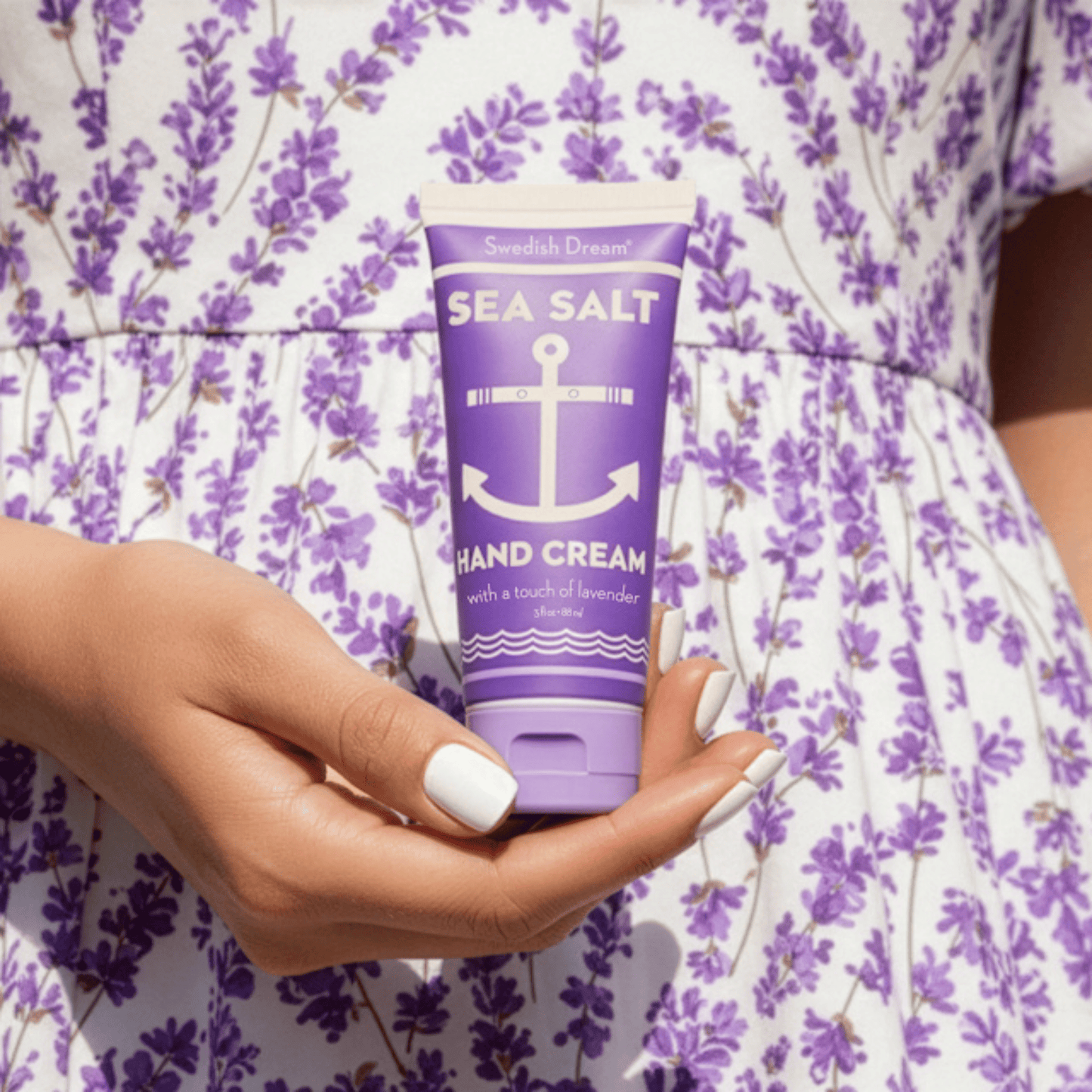 Alternate image if model holding purple hand cream bottle