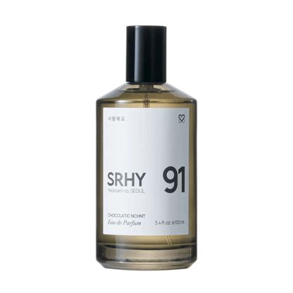 Primary Image of 91. Chocolatic Nchnt EDP, dark round perfume bottle with white label